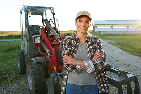 person in front of farming equipment